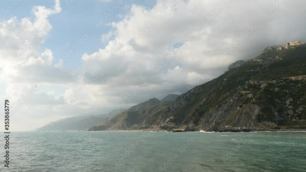 wavy sea and wind on a beach mountain background with clouds hatay samandag keldag turkey syria border