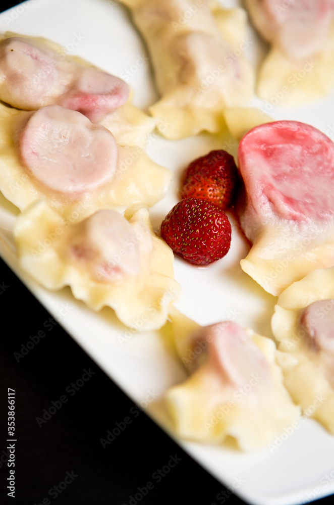 Plate of Polish strawberry dumplings in the kitchen. Plate of Polish strawberry dumplings in the kitchen.