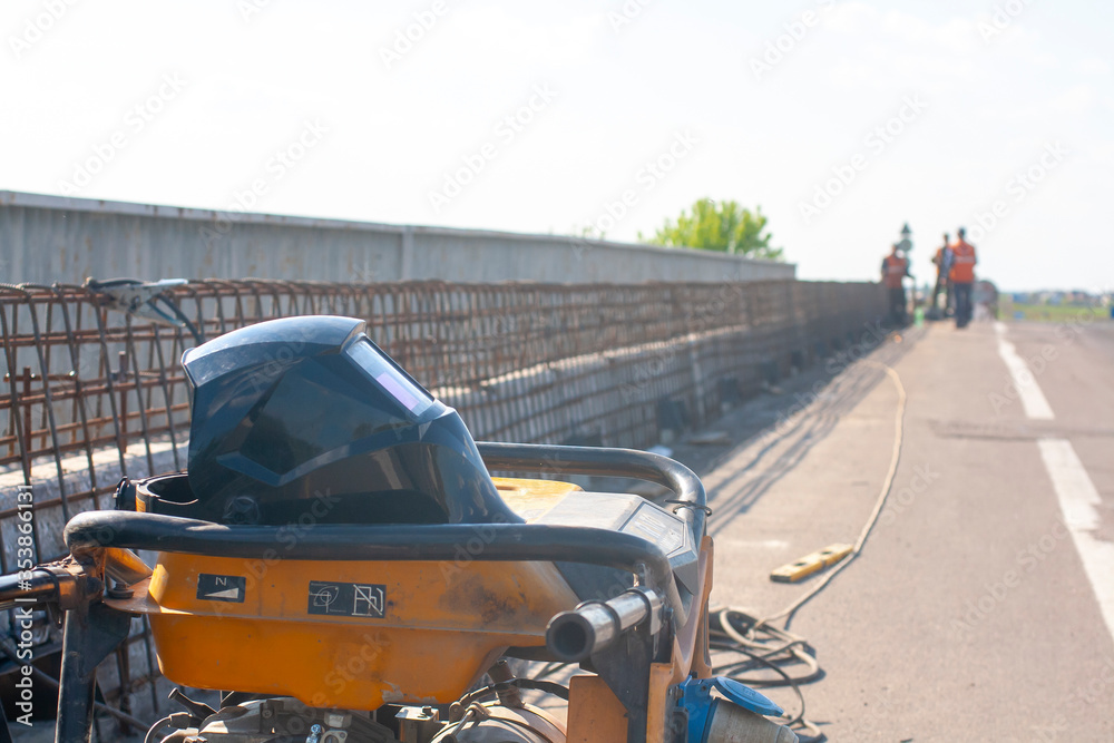 Bridge repair. Welding machine. Welders work on the bridge. Armature frame. Bridge repair. Welding machine. Welders work on the bridge. Armature frame.