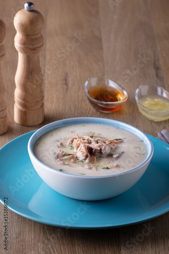 Turkish traditional tripe soup on rustic background with wooden table