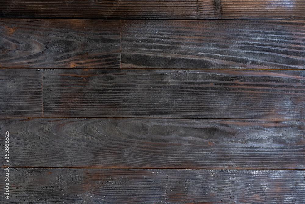 Fototapeta premium BBQ background. Burnt wooden Board texture. Burned scratched hardwood surface.