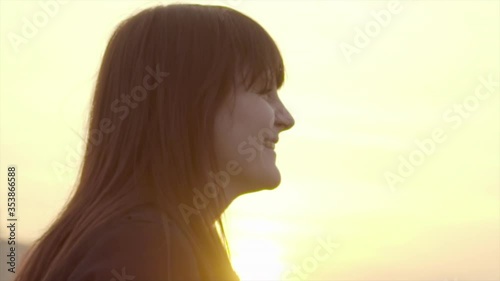 Close-up of playful beautiful young woman puckering against sky at sunset - Thuringia, Germany