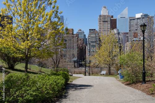 Empty Walkway with Green Trees and Grass at a Park on Roosevelt Island during Spring in New York City