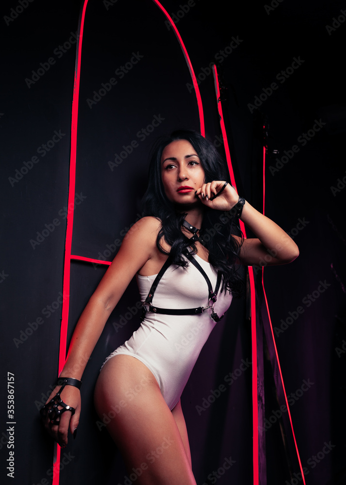 Hot sexy girl neon light dance night club leather harness dressed white  night-club Perfect female body with neon lettering on the background  Seductive female indoor Stock Photo | Adobe Stock
