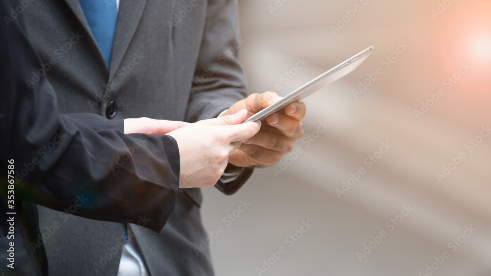 Close up businessman and woman using tablet to work.
