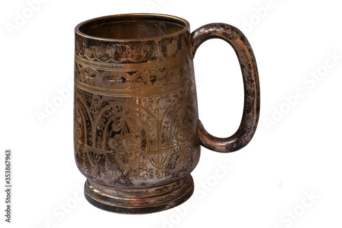 Old silver mug isolated. Shaded silver. Texture of silver sulfate on the surface of the cup.