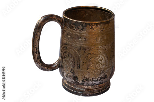 Old silver mug isolated. Shaded silver. Texture of silver sulfate on the surface of the cup.