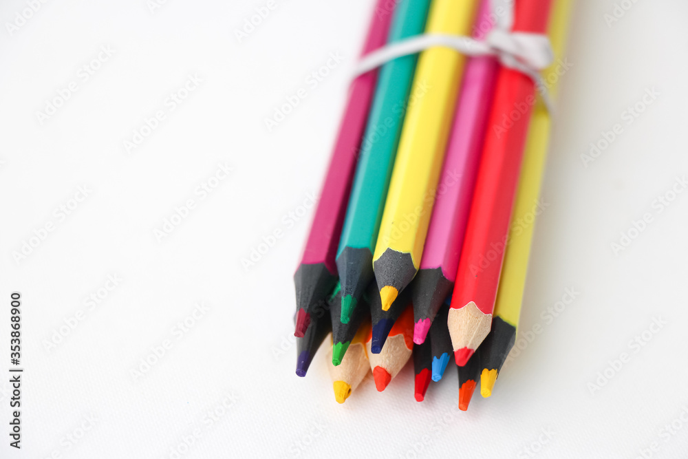 Colored pencils close-up on a white background. Back to school concept. Colored pencils close-up on a white background. Back to school concept.