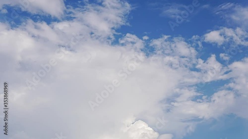 Time lapse white clouds in blue sky.