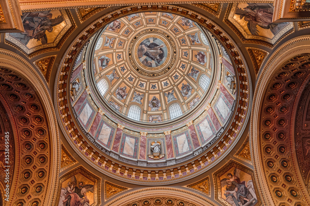 Budapest, Hungary - Feb 8, 2020: Upward view of gilded golden dome cupola inside St. Stephen's Basilica