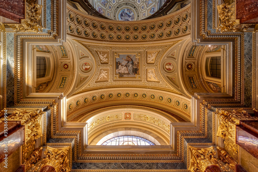 Budapest, Hungary - Feb 8, 2020: Upward view of gildded golden ceiling fresco inside St. Stephen Basilica