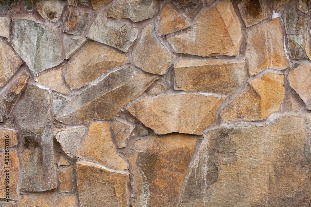 The texture of rough stone. Masonry from large boulders. Foundation. Building background. The texture of rough stone. Masonry from large boulders. Foundation. Building background.