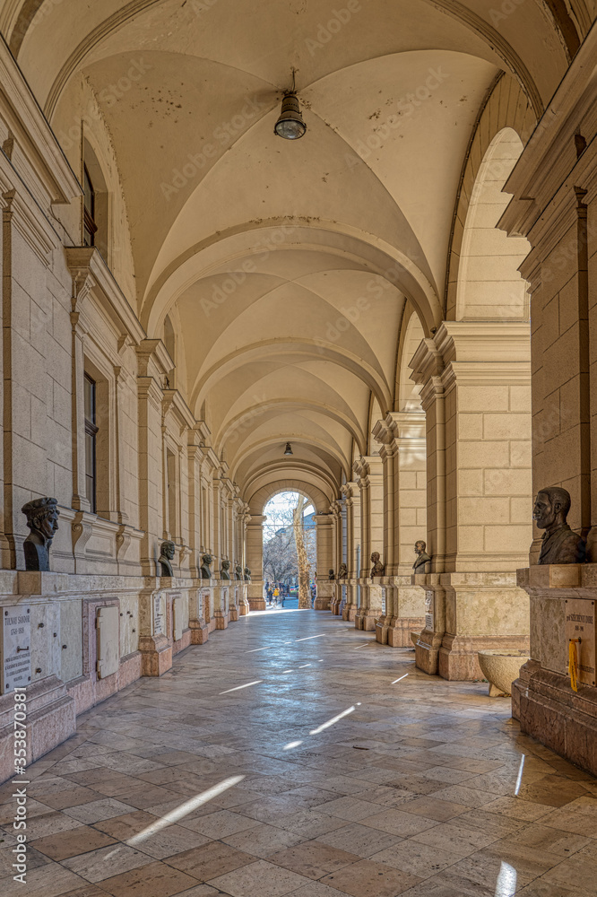Budapest, Hungary - Feb 8, 2020: Arcade passage with memorial busts on the wall near kossuth square