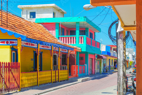Isla Mujeres colorful city architecture. an island in the Caribbean Sea. tourism attractions around Cancun vacation. Bright yellow and blue turqoise mexican latin america traditional houses.