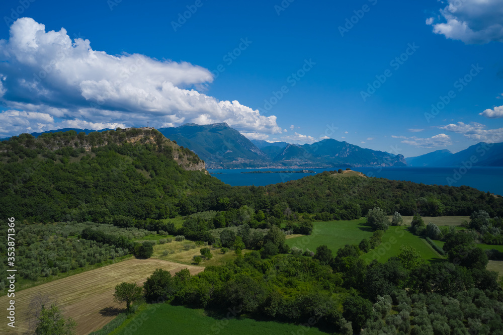 Lake Garda, Italy. Aerial view of rocca di manerba in the background alpine mountains garda island and Lacuale Park