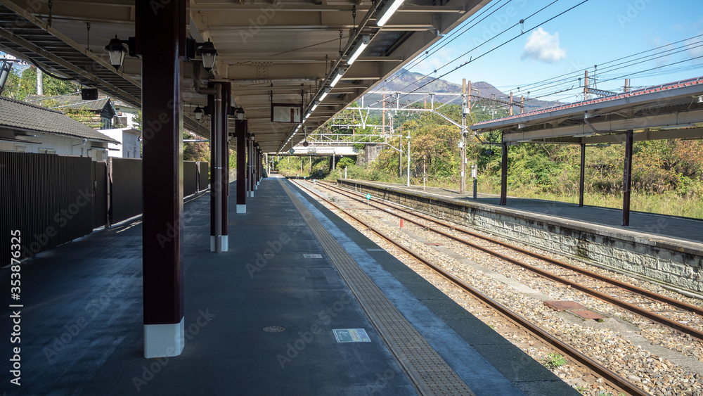 Empty platform at train station with metal sheet roof on clear blue sky background , copy space Empty platform at train station with metal sheet roof on clear blue sky background , copy space