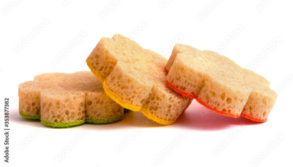 Brown flower-shaped sponges for washing dishes on a white isolated background.