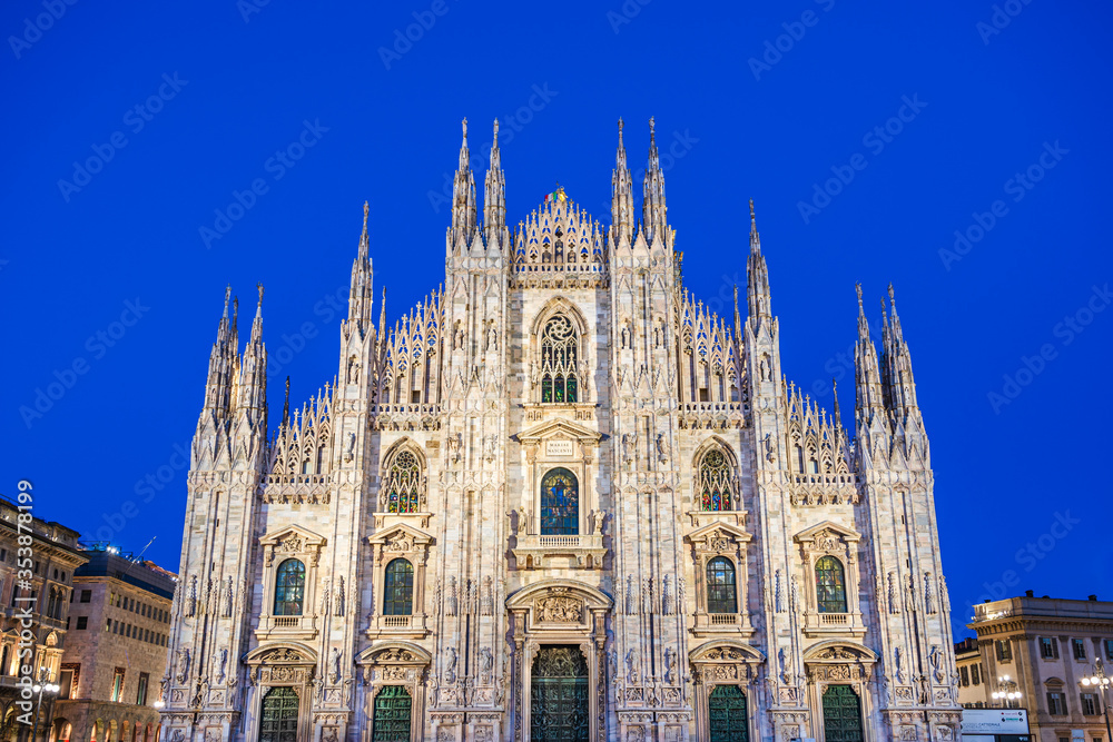 Sculptures and carvigs on the facade of the Cathedral of Milan at twilight in Milan, Lombardy, Italy