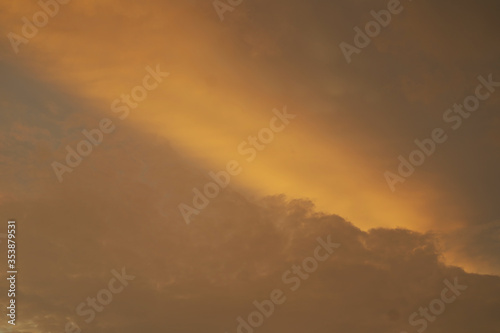 Beautiful vivid yellow sun cast over the cloud at sunset