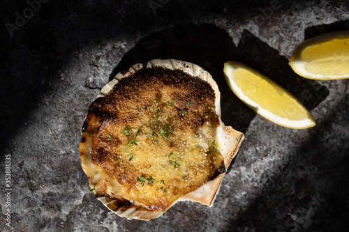 Coquille St Jacques scallop shellfish filled with white wine and cheese cream sauce, topped with breadcrumbs