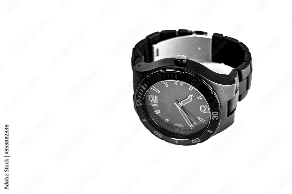Close-up detail of black clock on isolated white background. Copy space for text message. Top view. Close-up detail of black clock on isolated white background. Copy space for text message. Top view.