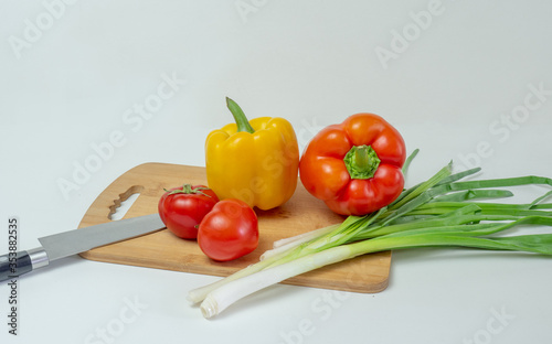 Delicious cuisine. Fresh vegetables on a wooden board, ready for slicing lettuce