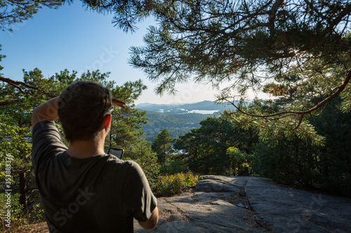 Man Looking Out at Landscape from Mountain Peak