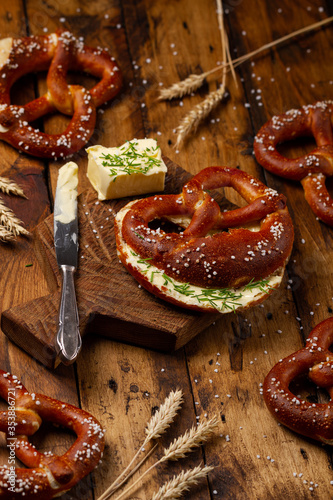 German Brezel pretzel with butter on wooden background. Butterbrezel photo