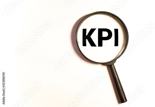 KPI. Magnifying Glass and black font of the word KPI