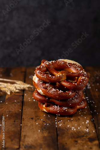 German Brezel pretzel with salt on wooden background