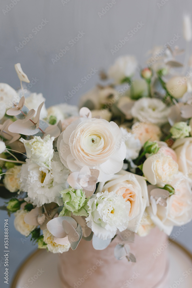 Beautiful bouquet of flowers in a box. A bouquet in peach tones. Stylish bouquet of peonies, ranunculis and roses. Flower shop concept. Floristics Beautiful bouquet of flowers in a box. A bouquet in peach tones. Stylish bouquet of peonies, ranunculis and roses. Flower shop concept. Floristics