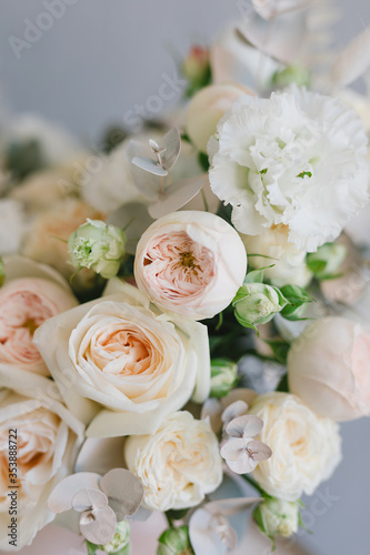 Beautiful bouquet of flowers in a box. A bouquet in peach tones. Stylish bouquet of peonies  ranunculis and roses. Flower shop concept. Floristics