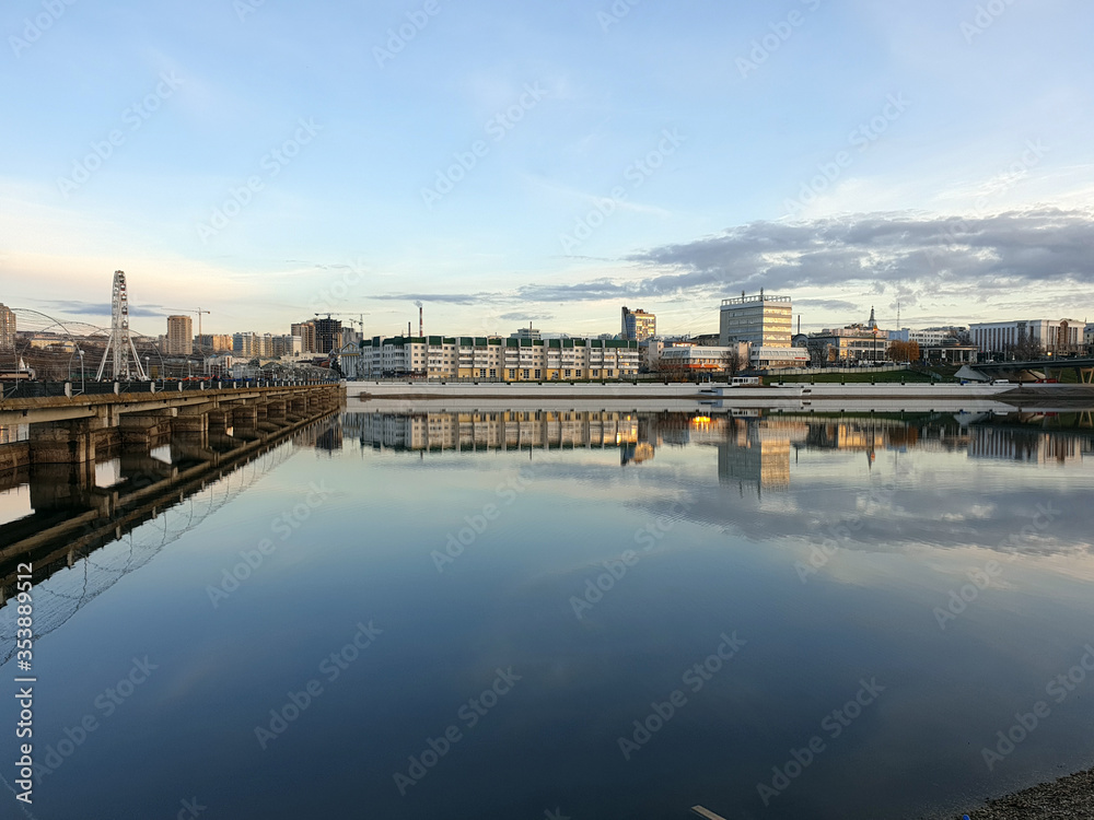 the city is reflected in the river