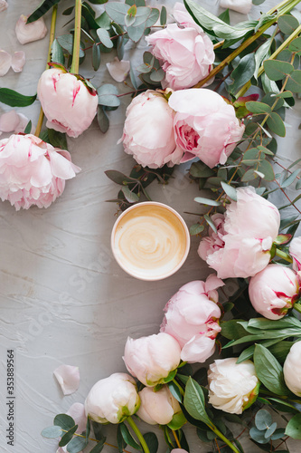 Coffee and flowers. Stylish composition of cappuccino and peonies.