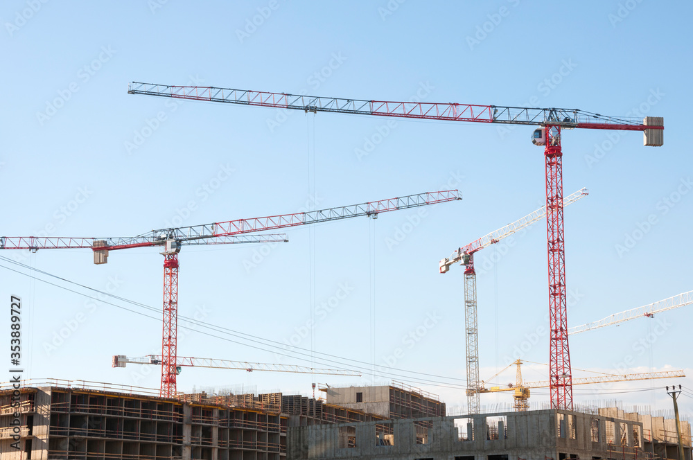 Few construction tower cranes build an apartment building