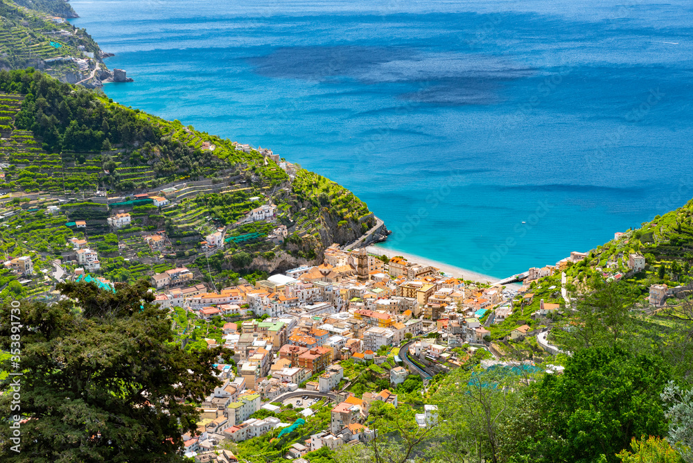 The village of Minori nestled in green hills seen from the Amalfi Coast road.