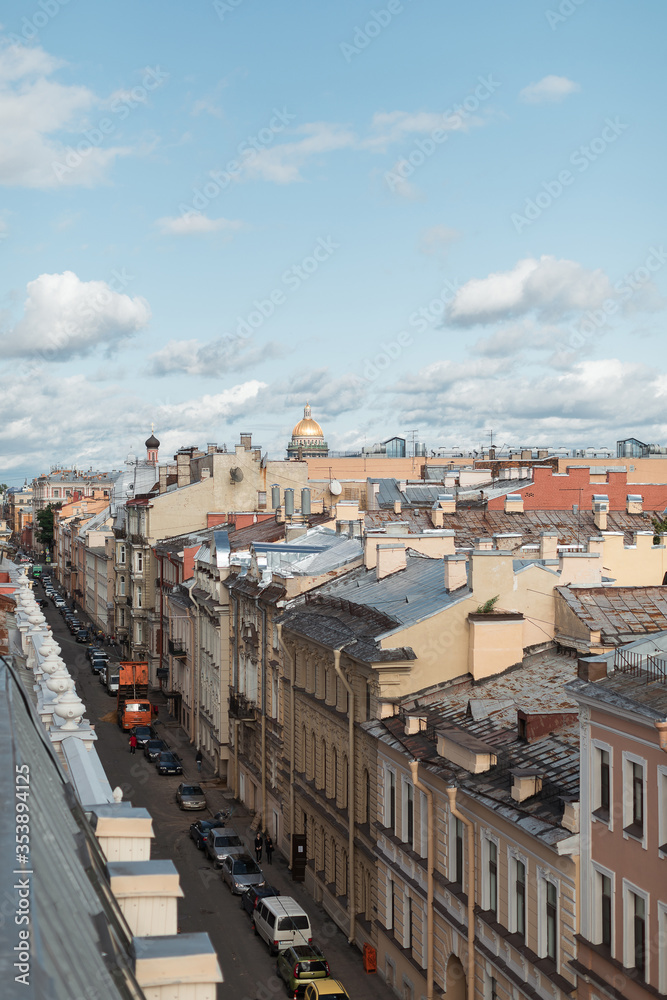 Sunset view at the Isaak Cathedral from the roof of Saint-Petersburg city. Ancient roof of the city. Old historical city. Amazing sunset at the top of the city