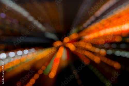 The abstract bokeh of the animated night in the street depicts the lively and beautiful nightlife. © soraview