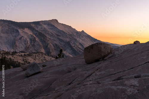 A huge boulder on one of the stone slopes next to Olmsted Lookout in Yosemite National Park at sunset