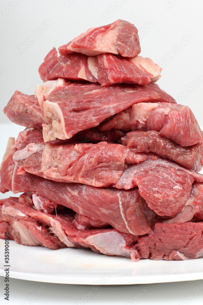 Pieces of chopped red meat on a white background