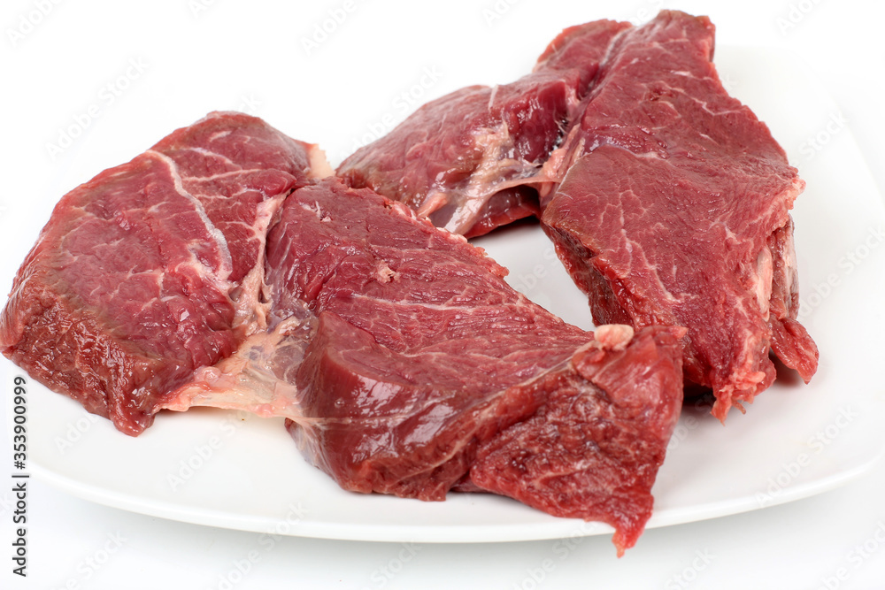 Pieces of chopped red meat on a white background