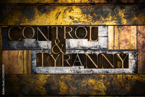 Photo of real authentic typeset letters forming Control and Tyranny text on vintage textured silver grunge copper and gold background
