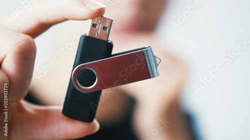 Woman holding a Pen Drive Flash USB Computer Memory Stick photo
