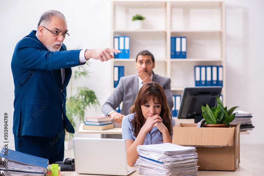 Two male and one female employees working in the office Two male and one female employees working in the office