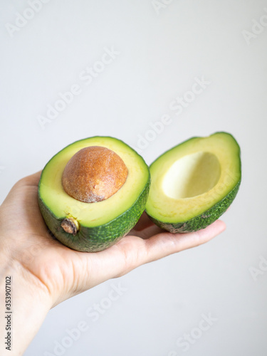 Green avocado on grey wall