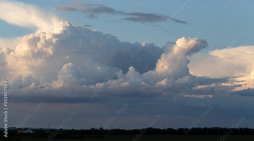 Landscape at sunset. Tragic gloomy sky. The village in the Budjak steppe. The terrain in southern Europe. Panorama.