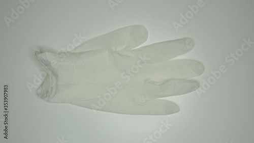 taking and wearing White and clean gloves and facial mask protection against covid19 frontal view
