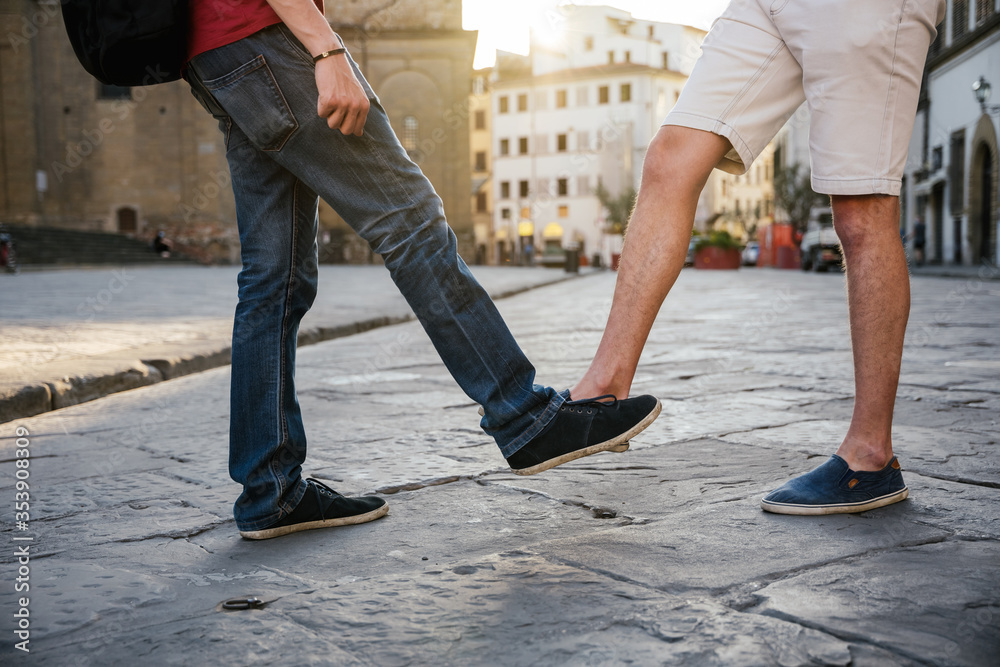 Two young friends meet city without contacts for fear of Corona virus infections, Covid-19, Millennials greet each other alternately without handshake with shoes protecting themselves from Coronavirus