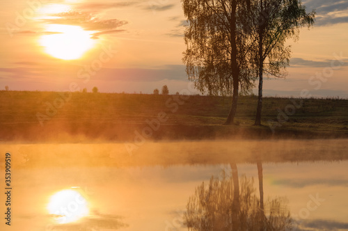 Landscape: fog or steam over lake at sunrise