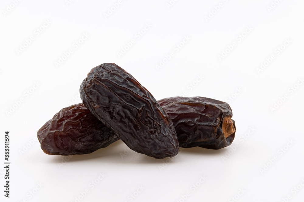 Delicious dried dates fruit in the heap isolated on white background Delicious dried dates fruit in the heap isolated on white background